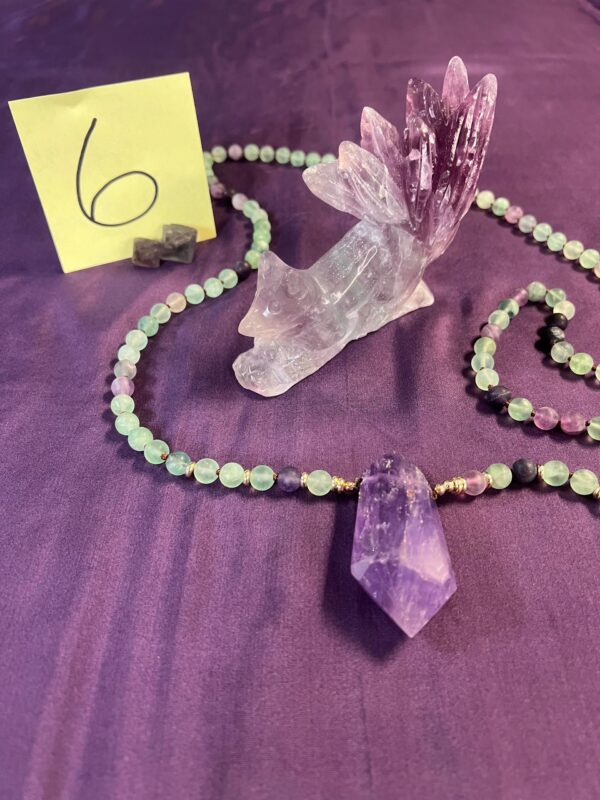 Amethyst crystal necklace with a fox figurine.