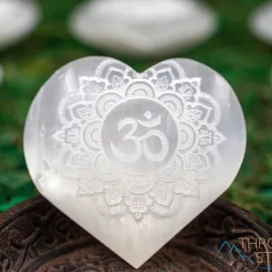 White selenite heart with om symbol.