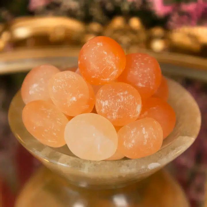 Bowl of round orange and white candies.