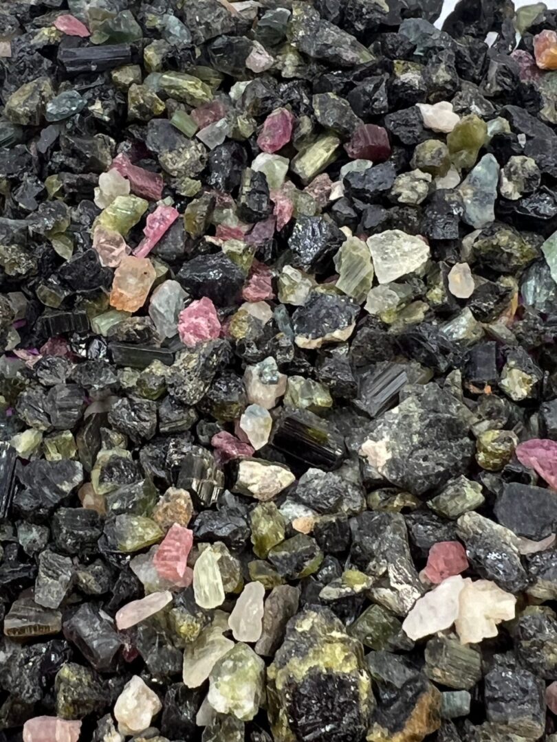 Collection of black, green, and pink stones.