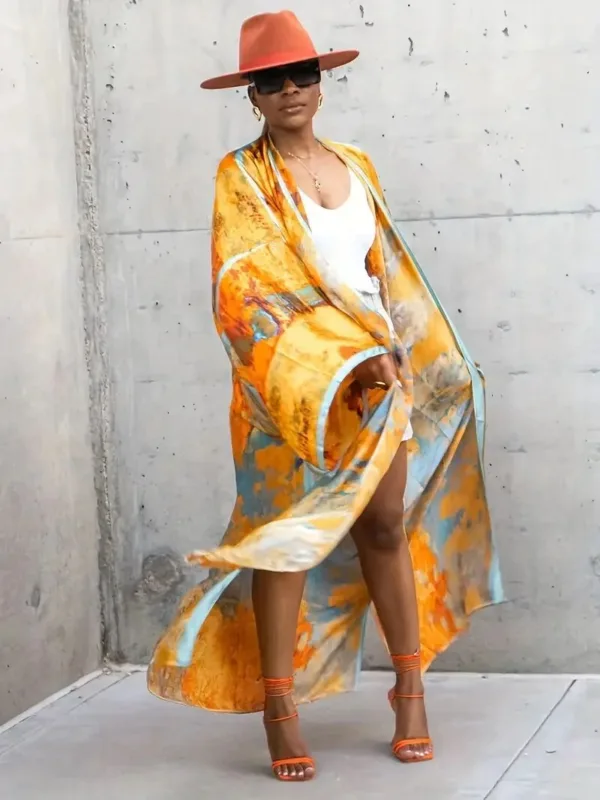 Woman wearing a floral kimono and hat.