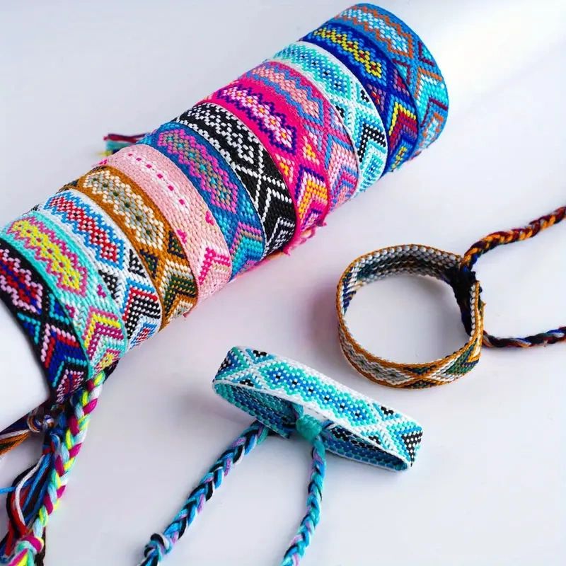 Colorful woven friendship bracelets on white background.