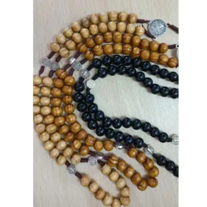 Wooden and black rosary beads with medallions.