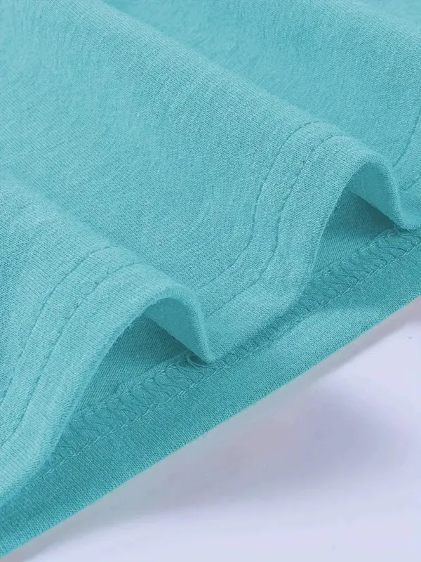 Close up of turquoise fabric with stitching.