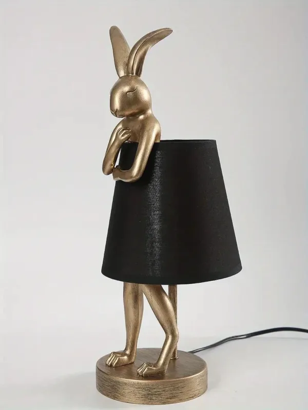 Gold rabbit lamp with black shade.