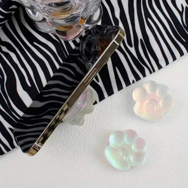 Two iridescent paw print phone grips.