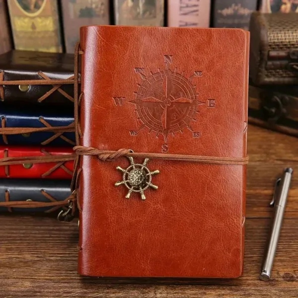 Brown leather journal with compass and anchor.