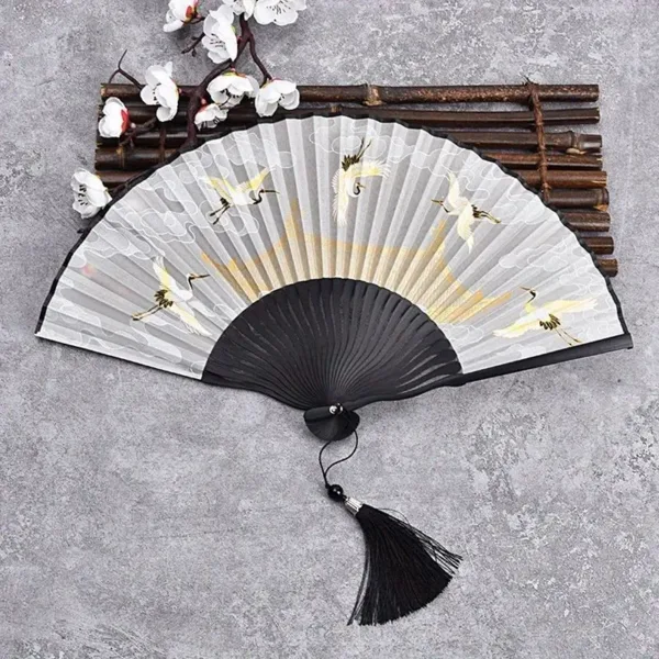 White crane hand fan with tassel.