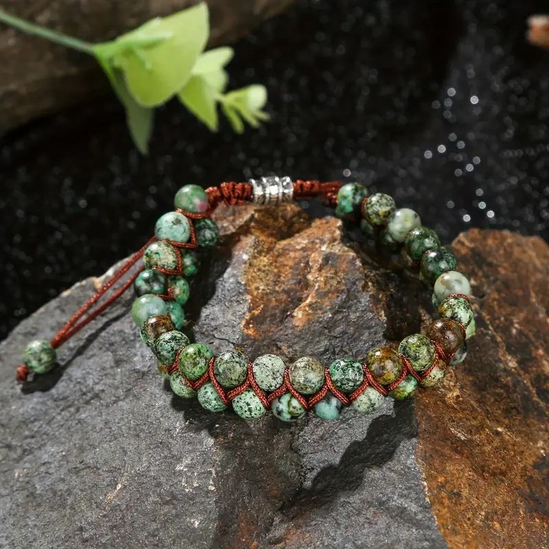 Green stone beaded bracelet on rock.