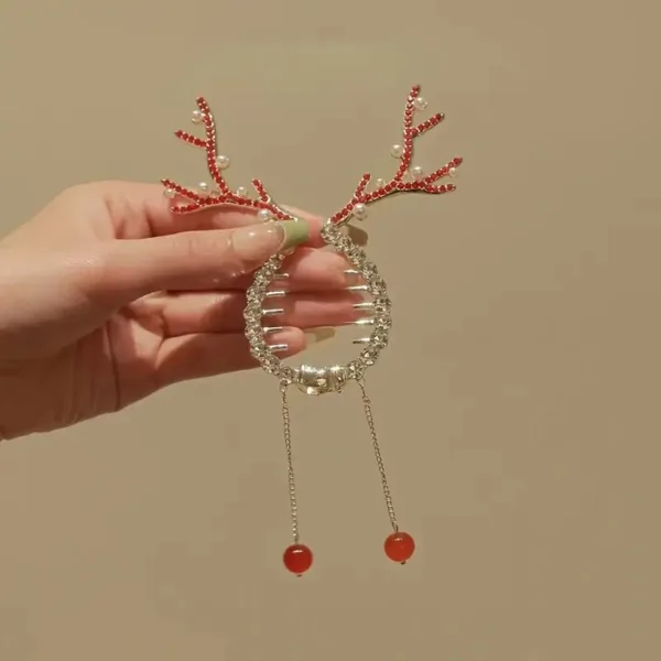 Rhinestone reindeer hair clip with red beads.