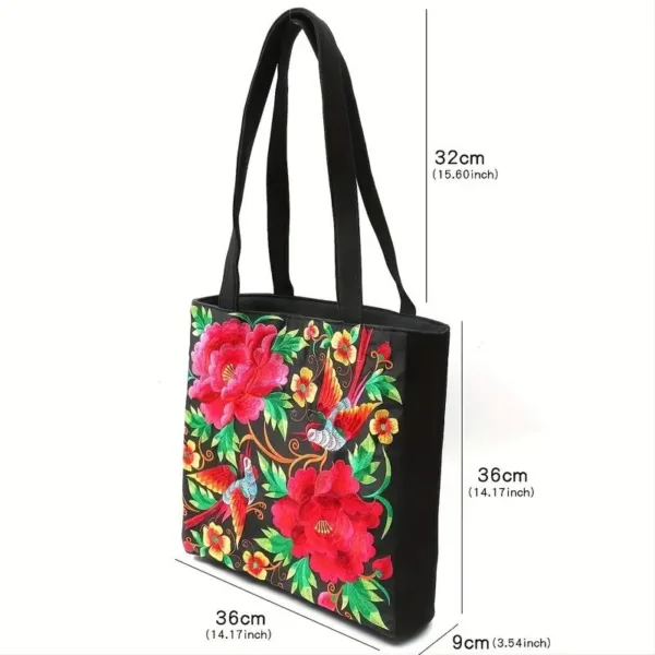 Black tote bag with floral embroidery.