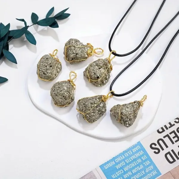 Pyrite stone pendant necklaces on white background.