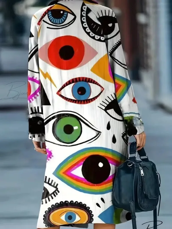 Woman in eye print dress with bag.