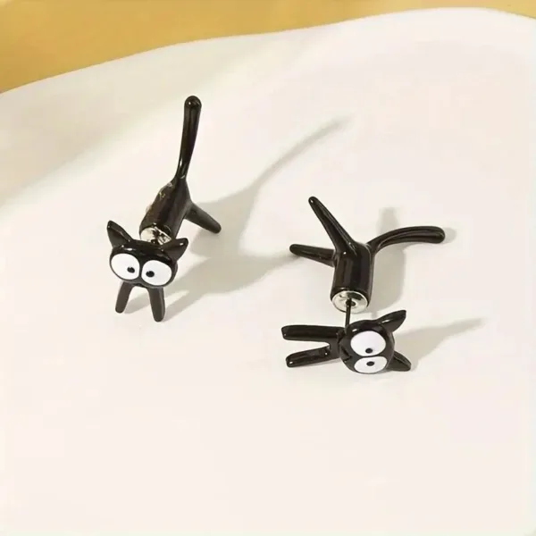 Black cat stud earrings on white background.