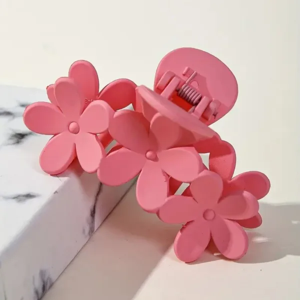 Pink flower-shaped hair claw clip.