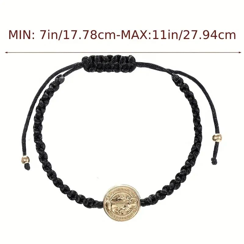 Black cord bracelet with gold medal.