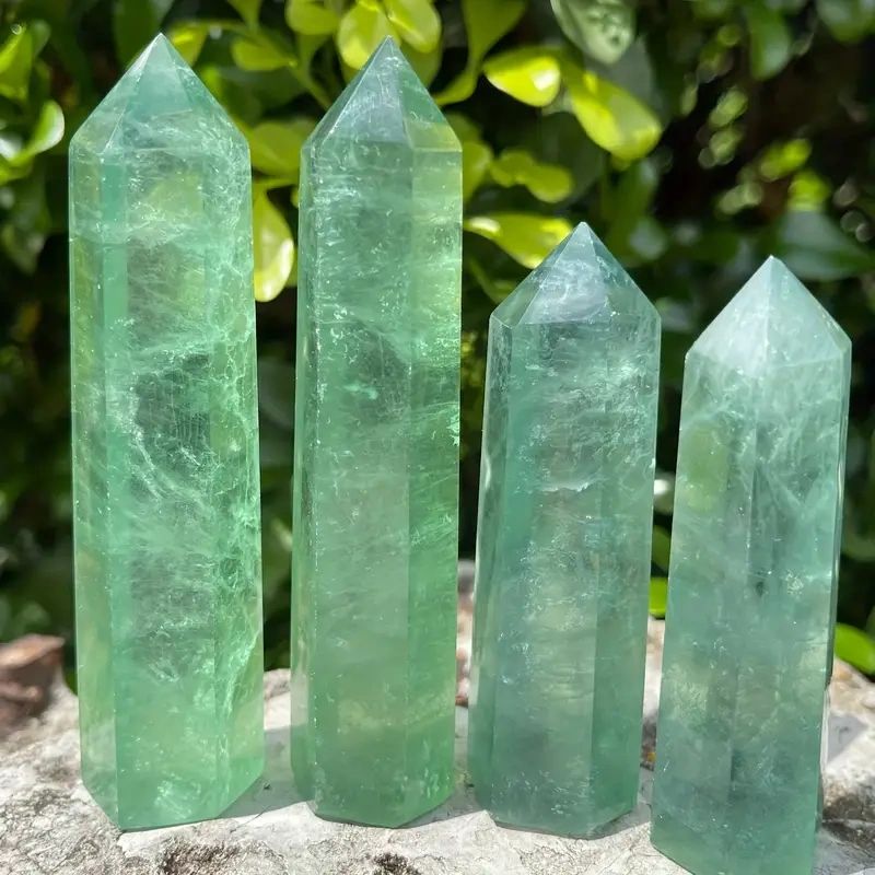 Four green fluorite crystal points.