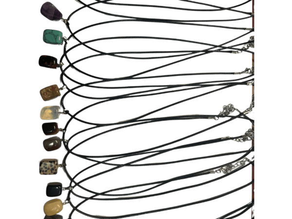 Multiple gemstone necklaces on black cords.