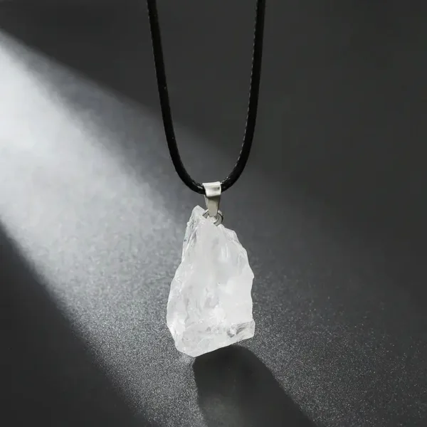 Clear quartz crystal pendant on black cord.