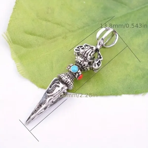 Silver ornate dagger pendant with turquoise stones.