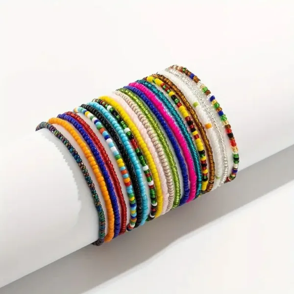 Multicolored beaded bracelets on white background.