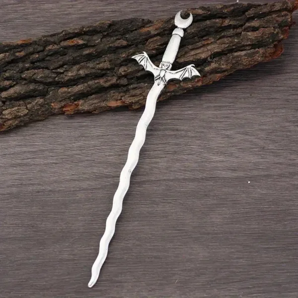 Silver bat sword hair stick on wood.