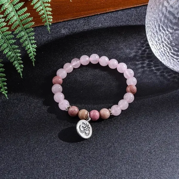 Pink and brown beaded bracelet with Om charm.