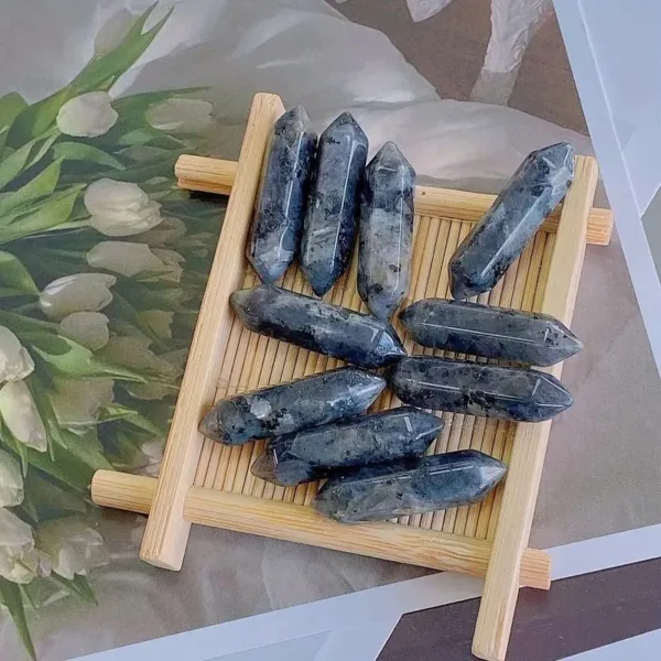 Black and gray crystal points on wood tray.