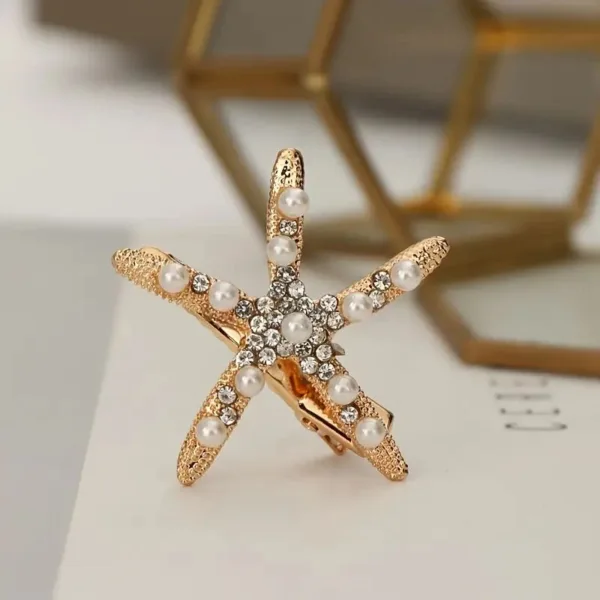 Gold starfish hair clip with pearls.