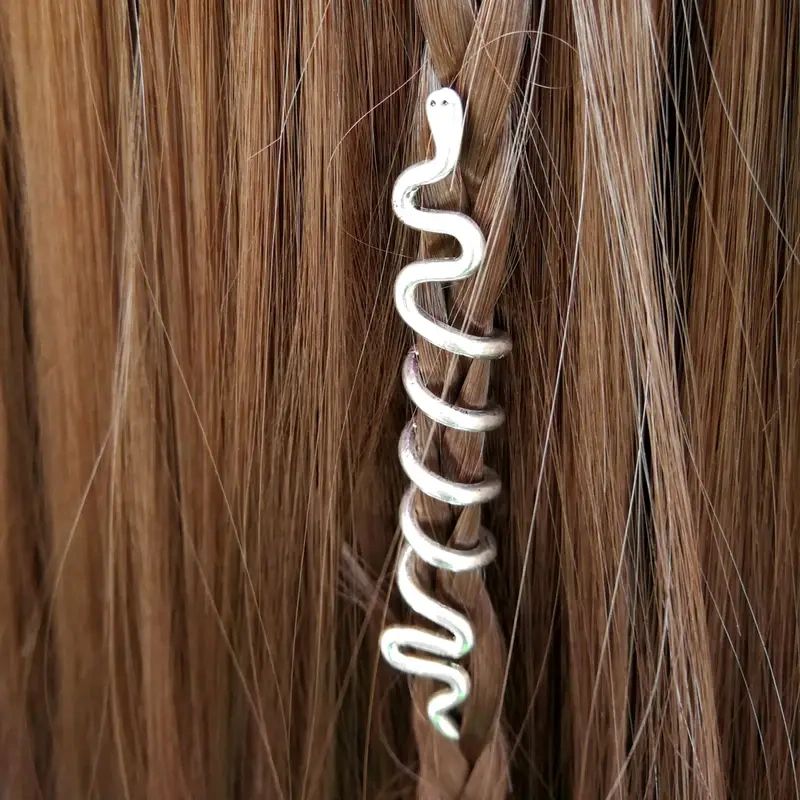 Silver snake hair clip in braid.