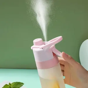 Pink spray bottle with water mist.