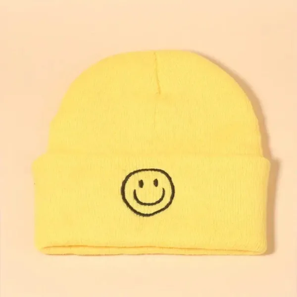 Yellow beanie with a smiley face.