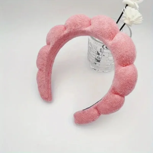 Pink fluffy headband for hair styling.