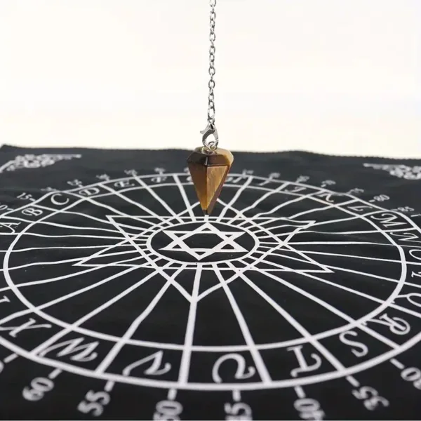 Black and white pendulum board with a tiger eye pendulum.