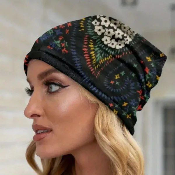 Woman wearing a patterned black beanie.