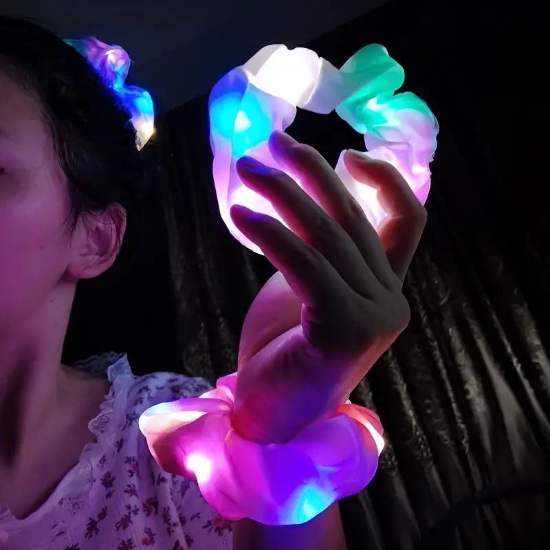 Person wearing glowing colorful hair ties.