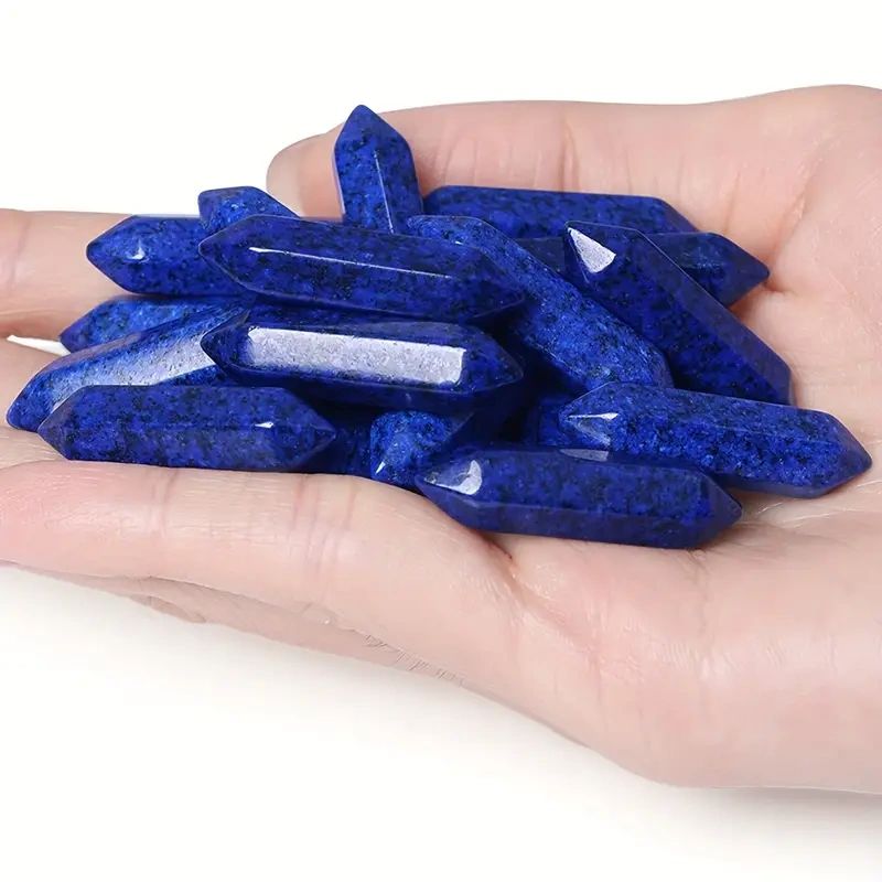 Hand holding blue lapis lazuli points.