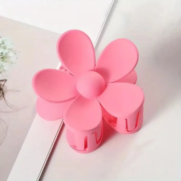 Pink flower shaped hair clip.