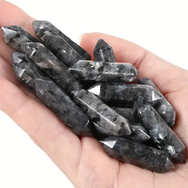 Black and grey crystal points in hand.