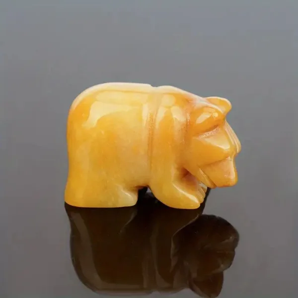 Carved yellow jade bear figurine.