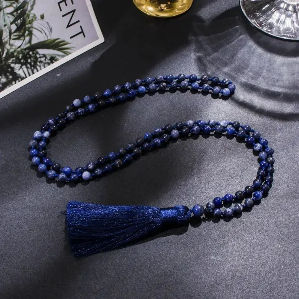 Blue gemstone necklace with tassel.