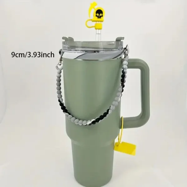 Green travel mug with beaded handle and straw.