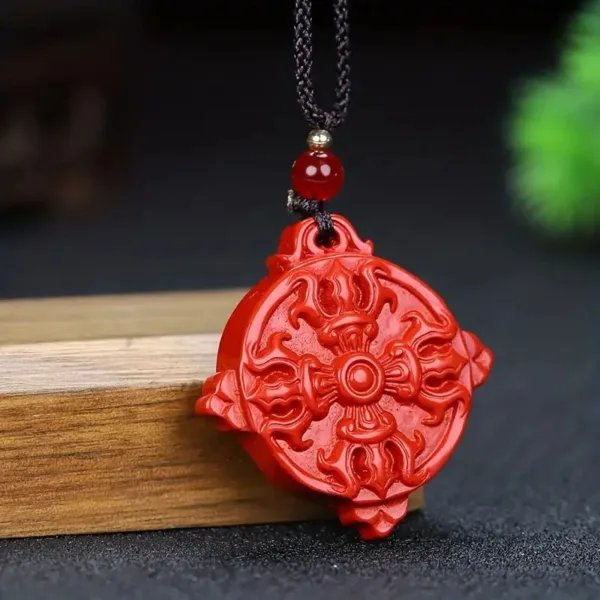 Red carved pendant with a black cord.