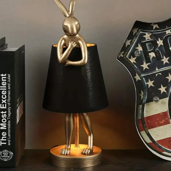 Gold rabbit lamp with black shade.