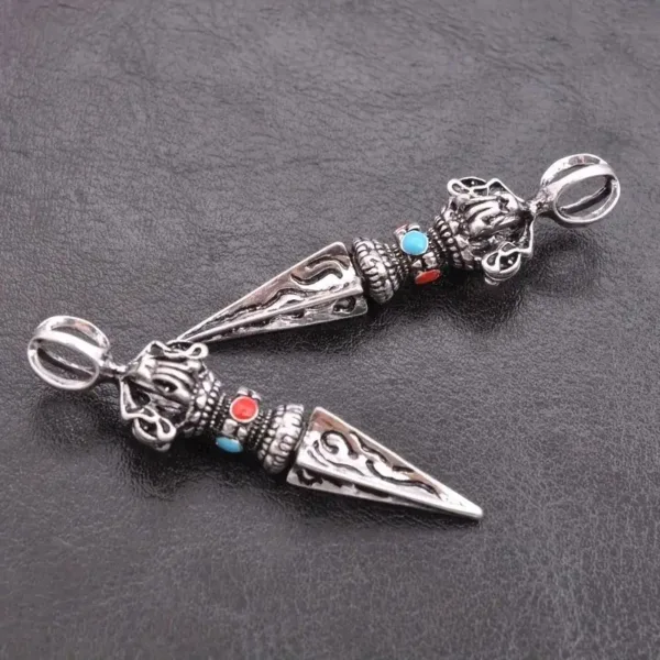 Two ornate silver pendants with gems.