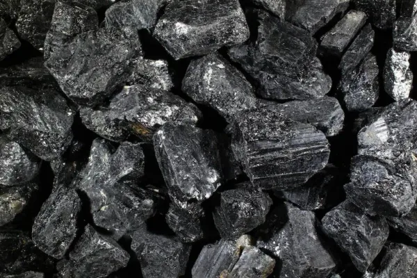 Black tourmaline crystal pile close-up.