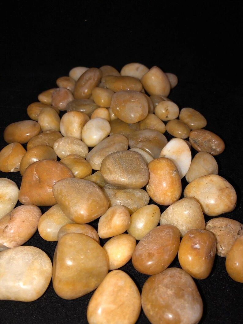 Pile of smooth tan river rocks.