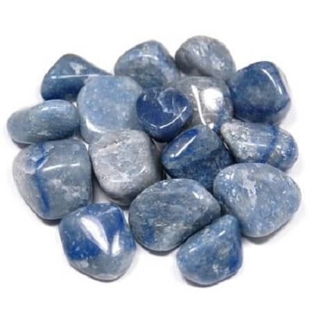 Blue quartz tumbled stones on white background.