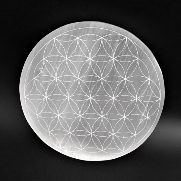 White selenite disc with flower of life design.