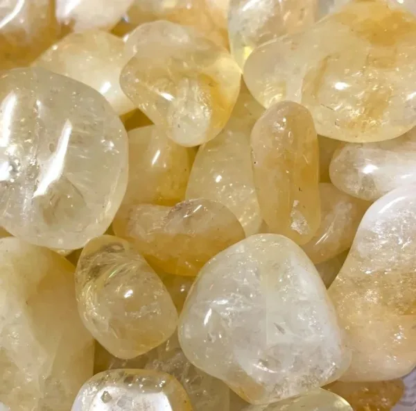 Close up of smooth yellow citrine stones.